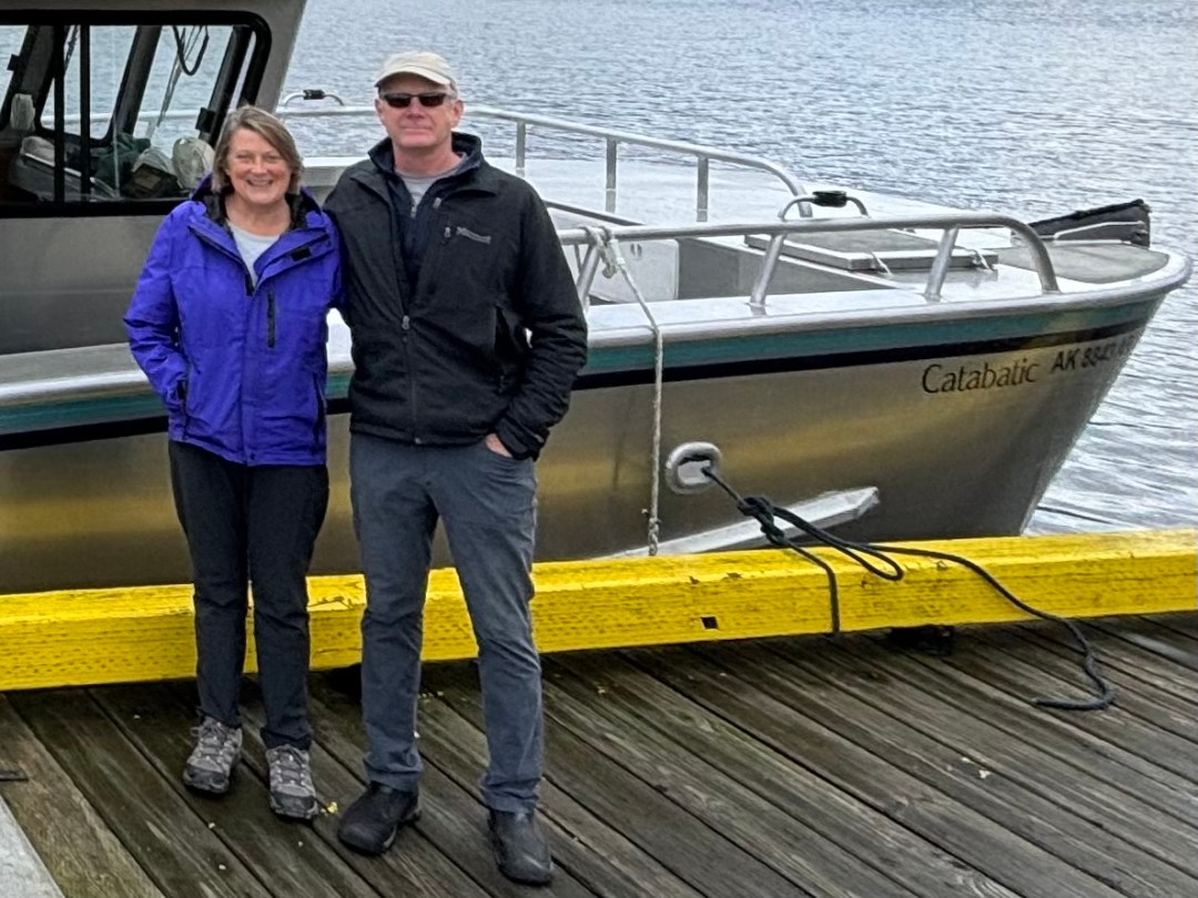 Laimdota Straujuma standing in front of a boat